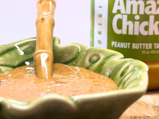 Close-up of homemade nut-free Thai 'peanut' sauce with a jar of The Amazing Chickpea beside it