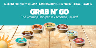 Assorted The Amazing Chickpea mini cups on a wooden surface with promotional text about allergy-friendliness, vegan status, plant-based protein, and no artificial flavors.